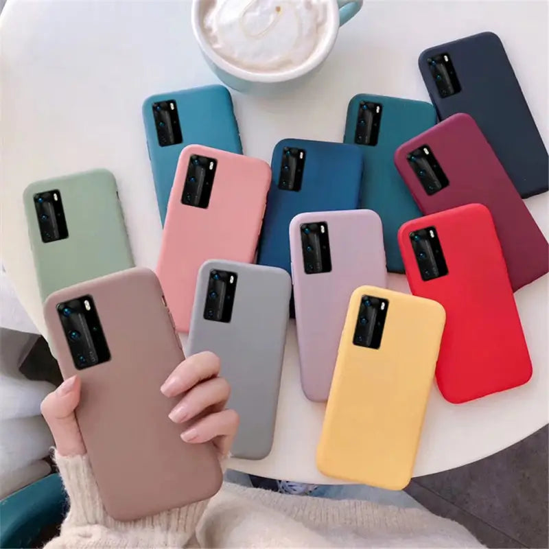 a woman holding a phone case with multiple colors