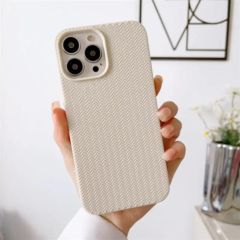 a woman holding a phone case with a white pattern