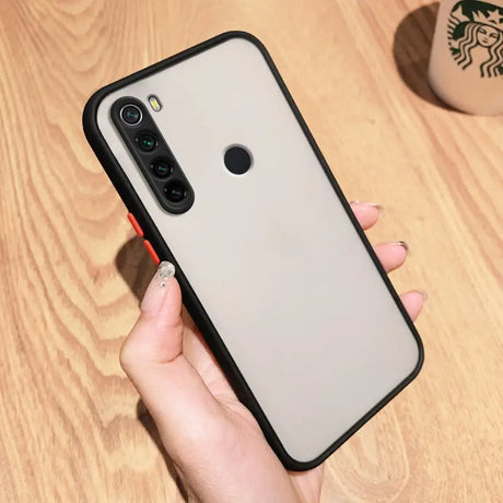 a woman holding a phone case with a black and white design