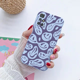 a woman holding a phone case with a pattern on it