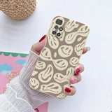 a woman holding a phone case with a pattern on it