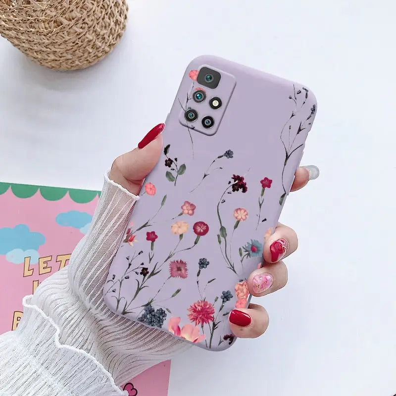 a woman holding a phone case with flowers on it