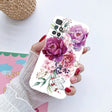 a woman holding a phone case with flowers on it