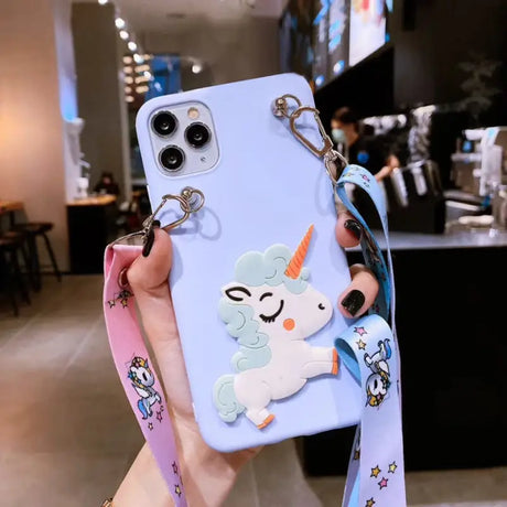 a woman holding a phone case with a unicorn on it