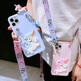 a woman holding a phone case with unicorns on it
