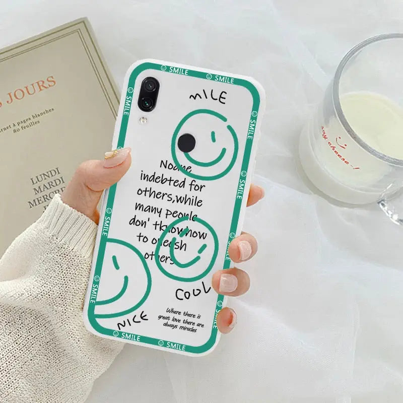 a woman holding a phone case with a quote on it