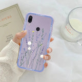 a woman holding a phone case with flowers on it