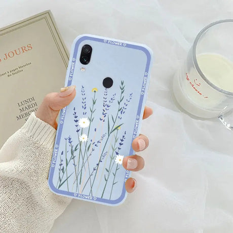 a woman holding a phone case with a flower design