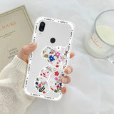 a woman holding a phone case with a flower design