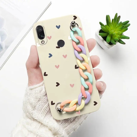 a woman holding a phone case with a heart pattern