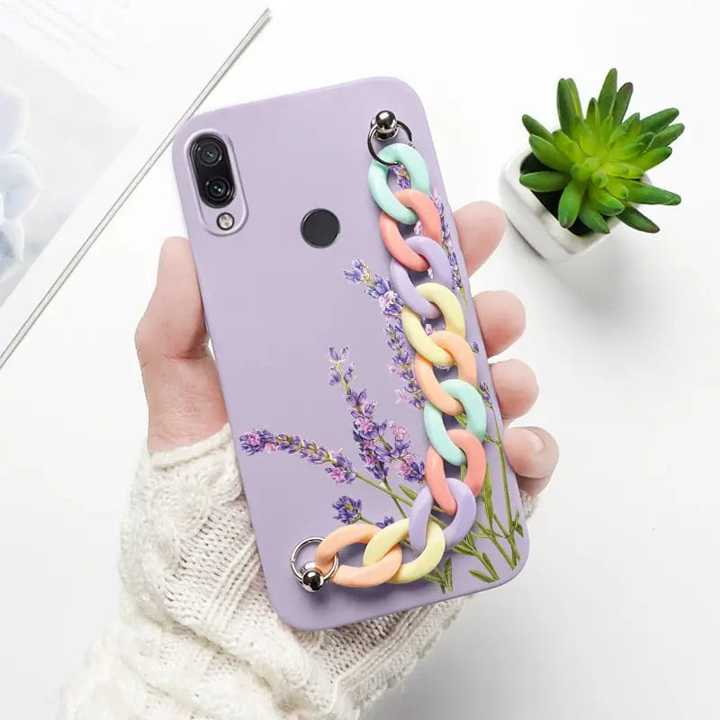 a woman holding a phone case with a flower design