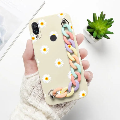 a woman holding a phone case with a flower design