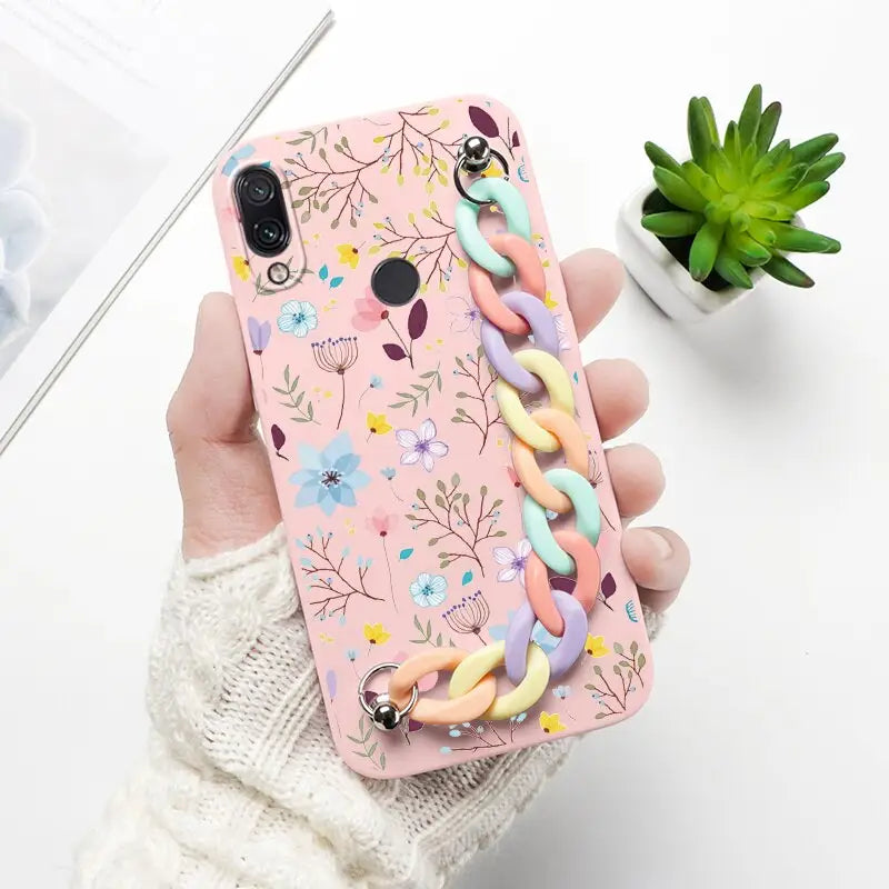 a woman holding a phone case with a unicorn on it