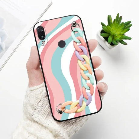 a woman holding a phone case with a colorful pattern