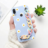 a woman holding a phone case with a flower design