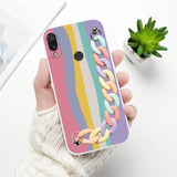 a woman holding a phone case with a rainbow colored pattern