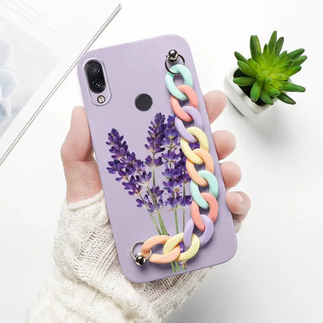 a woman holding a phone case with a flower on it