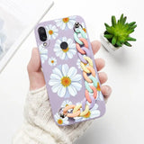 a woman holding a phone case with flowers on it