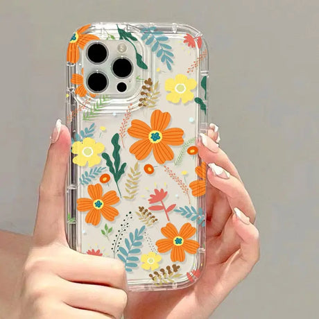 a woman holding a phone case with flowers on it