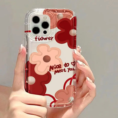 a woman holding a phone case with a flower design