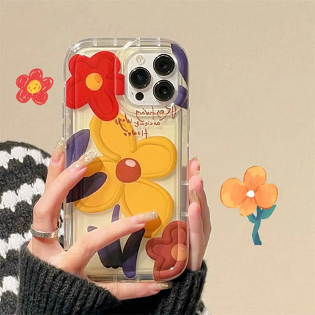 a woman holding a phone case with flowers on it