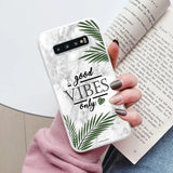 a woman holding a phone case with the words good vibes on it