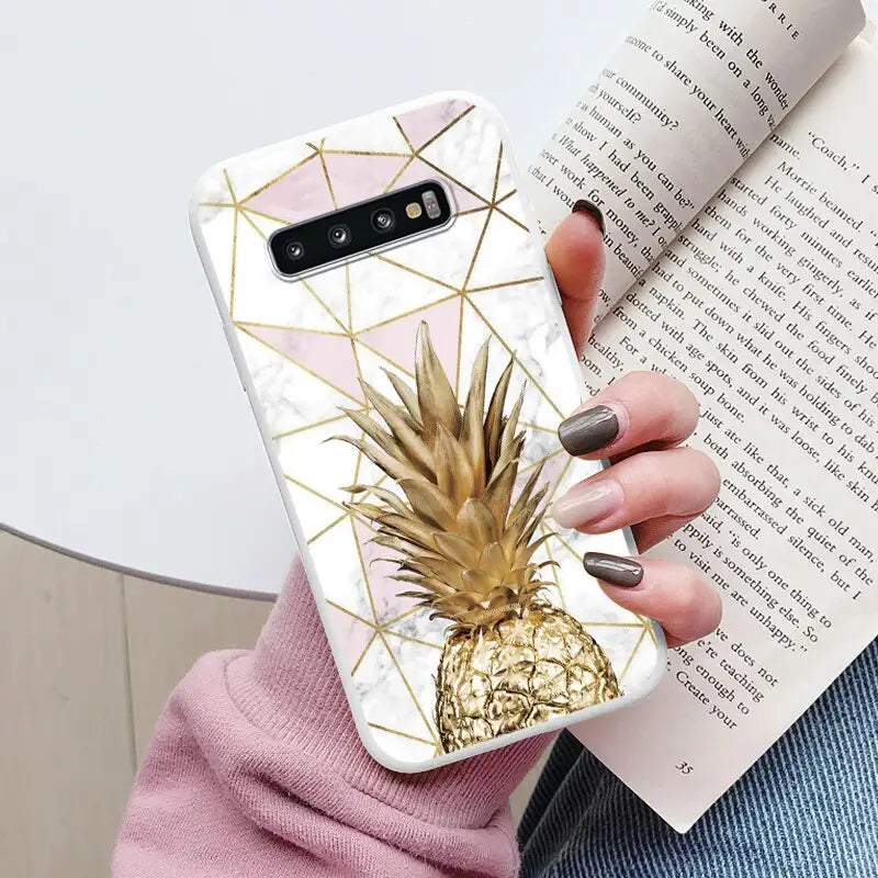 a woman holding a phone case with a pine on it