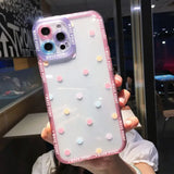 a woman holding a phone case with polka dots