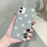 someone holding a phone with a daisy pattern on it