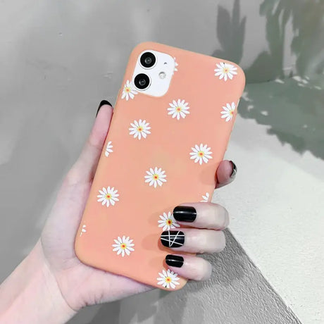 someone holding a phone case with a flower pattern on it