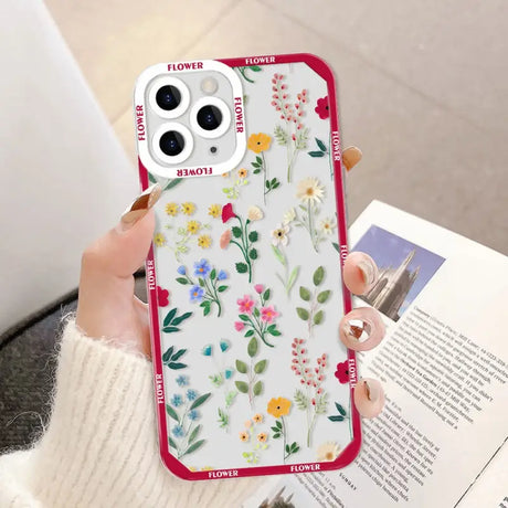 a woman holding a phone case with flowers on it