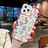 a woman holding a phone case with flowers on it