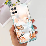 a woman holding a phone case with a butterfly and flowers on it