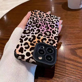 a woman holding a cell case with a leopard print