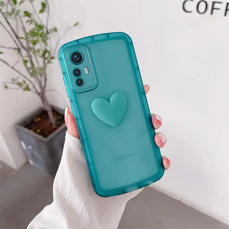 a woman holding a phone case with a heart on it