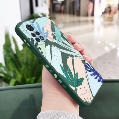 a woman holding a phone case with a floral pattern