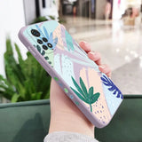 a woman holding a phone case with a colorful floral design