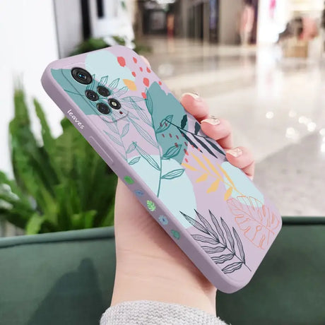 a woman holding a phone case with a floral design