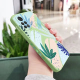 a woman holding a phone case with a colorful floral design