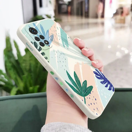 a woman holding a phone case with a colorful floral design