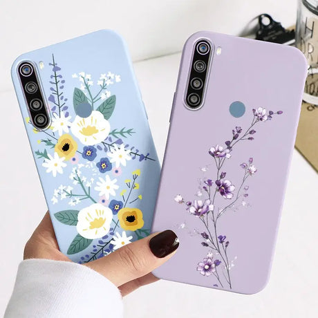 a woman holding a phone case with flowers on it