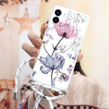 a woman holding a phone case with flowers on it