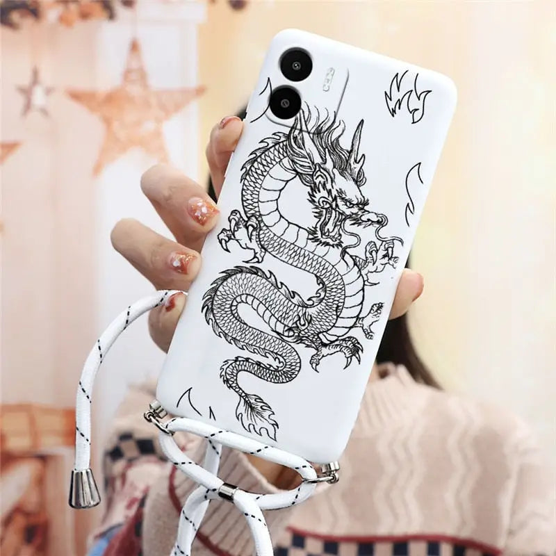 a woman holding a phone case with a dragon on it