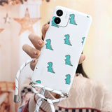 a woman holding a phone case with a green dinosaur pattern