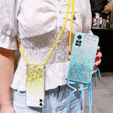 a woman holding a phone case with a yellow strap