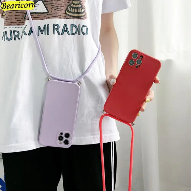 a woman holding a cell phone case