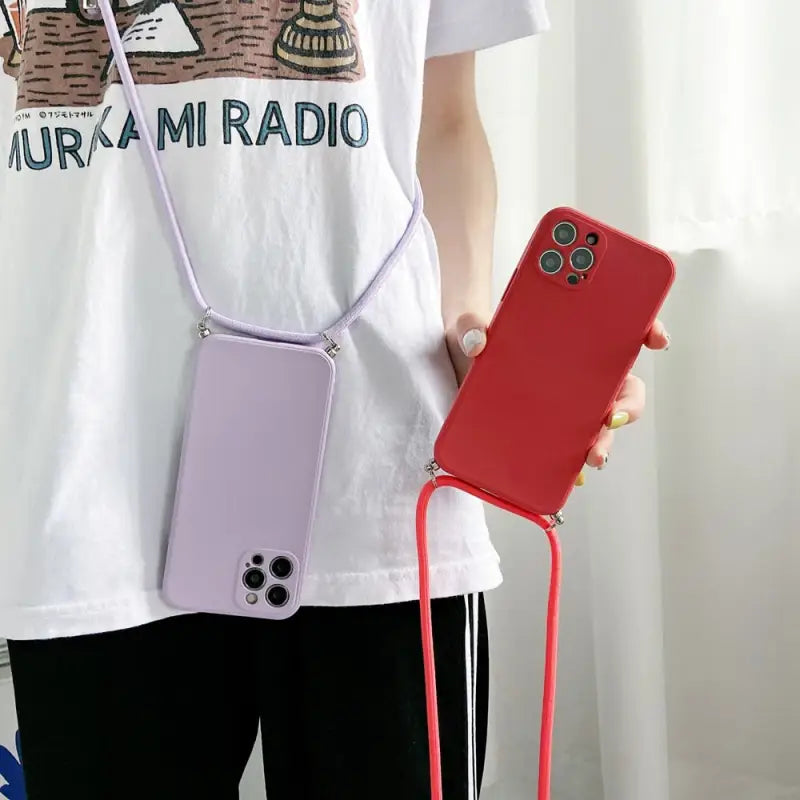 a woman holding a phone case with a strap