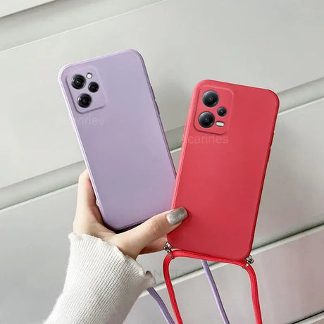 a woman holding a phone case with a red and purple case