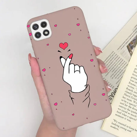 a woman holding a phone case with a heart on it