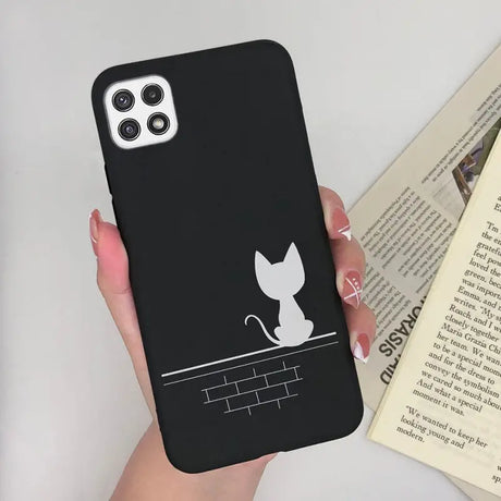 a woman holding a phone case with a cat on it